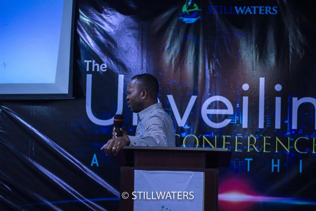 A speaker delivers a message from the podium at The Unveiling Conference, hosted by Stillwaters Ministries.